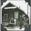 Group of men outside building with sign, Reno Junction (ddr-ajah-2-283)