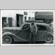 Nisei soldier in front of a car (ddr-densho-164-26)