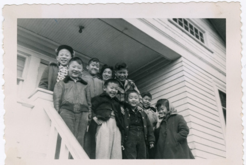 Group of children on porch steps (ddr-densho-456-24)