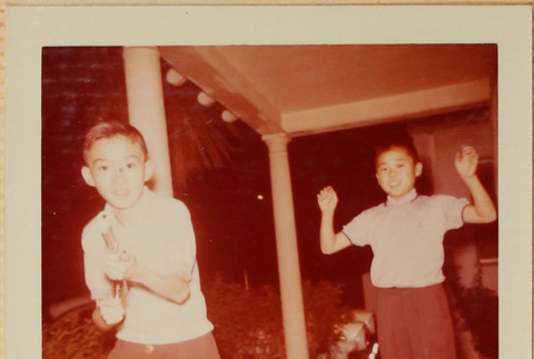 Two boys playing with toy gun (ddr-densho-522-514)