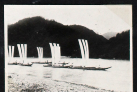 Six boats sail near a beach (ddr-densho-404-125)