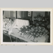Flowers drape Sangoro Mii's casket (ddr-densho-37-933)
