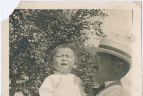 A man holding a crying child (ddr-densho-338-201)