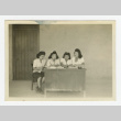 Nisei women working at desk in front of barrack (ddr-csujad-44-45)