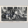 Group of women in front of a car (ddr-manz-10-1)