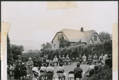 Photo of a large group meeting in a yard (ddr-densho-483-1377)