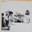 Women standing by open car door (ddr-densho-522-99)