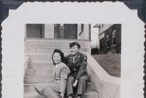 Couple sitting on steps in front of house (ddr-densho-467-16)