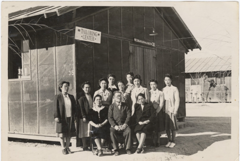 Group in front of the tailoring center at Poston (ddr-densho-427-1)