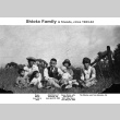 Shiota family sitting in field (ddr-ajah-6-868)
