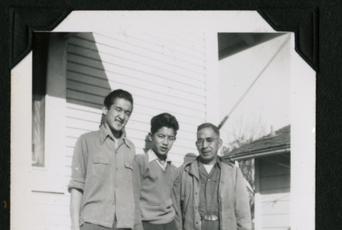 Walter, David, and Harry Matsuoka stand against a building (ddr-densho-390-54)