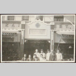 A group posing in front of a business (ddr-densho-278-54)