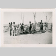 Men planting trees with camp buildings in background (ddr-densho-329-1373)