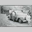Photograph of the Merritt family surrounding a car in Titus Canyon in Death Valley (ddr-csujad-47-143)