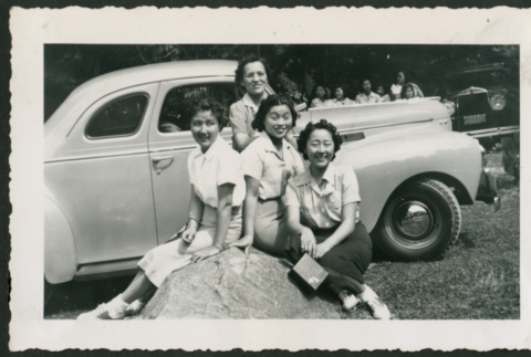 Women pose in front of car (ddr-densho-359-129)