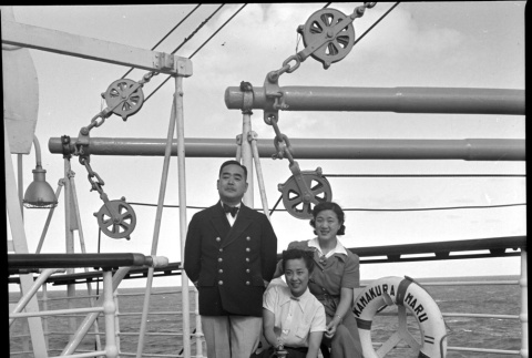 Man and two women on board ship (ddr-densho-426-259)