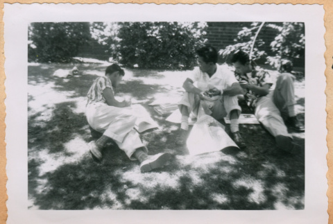 Photo of three young men on lawn (ddr-densho-341-210)