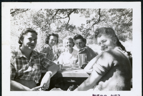 Photograph of five women sitting around a picnic bench, including Lucy Adams, Gertrude Wetzel, Bernice Sibner, and Lucy Wilcox (ddr-csujad-47-303)