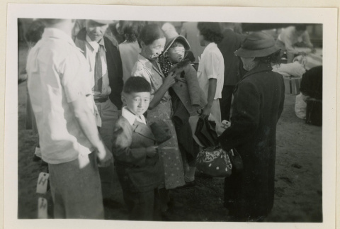 Family ready to board a train (ddr-densho-37-911)