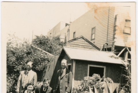 Tomoye (Nozawa) Takahashi and Tomoyuki Nozawa with two unidentified men in garden (ddr-densho-426-2129)