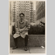 Man seated in front of building (ddr-densho-426-83)
