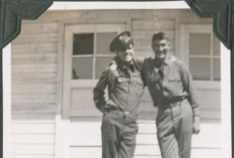 Two men in uniform on steps of barracks (ddr-ajah-2-87)