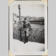 Man leaning on railing by river (ddr-densho-466-839)