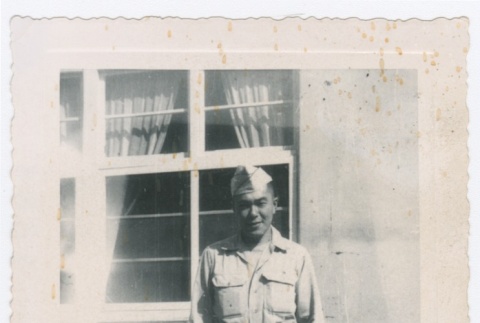 Man in US Army uniform standing in front of building (ddr-densho-332-28)