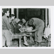 Surgeon Lt. Milton B. Sorem treating Okinawan girl (ddr-densho-1007-81)