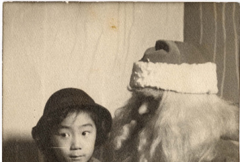 Photo of Diana Lynn Reiko Morita with Santa (ddr-densho-409-5)