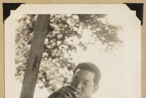 Roy Sumida smoking a cigarette (ddr-densho-542-556)