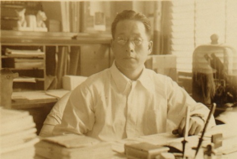 Ryojun Kinoshita seated at his desk (ddr-njpa-4-602)