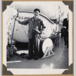Gary Kikawa poses next to a lifeboat (ddr-densho-542-350)