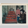 4 generations of Sumida women posing in front of Japanese doll collection (ddr-densho-379-445)