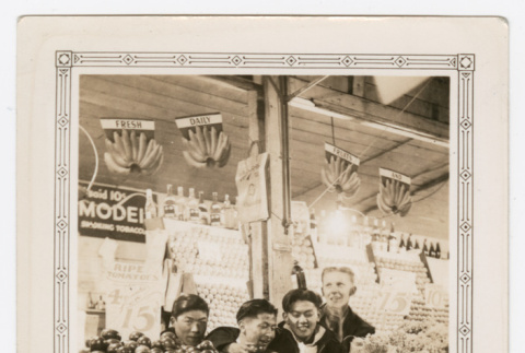 Four men sitting at fruit stand photo (ddr-densho-540-21)