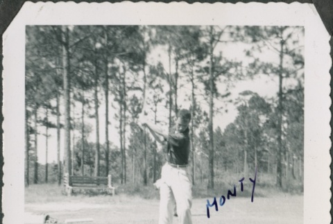 Man swings golf club (ddr-densho-321-388)