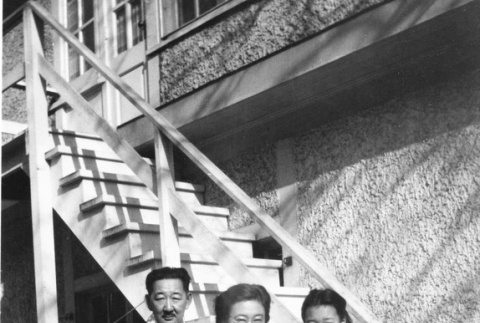 Ishii family standing next to a white wooden staircase (ddr-csujad-50-5)