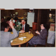 Three people at a table with a table in the background (ddr-densho-426-1279)