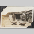Man and woman processing rice (ddr-densho-326-323)