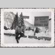 Man sitting in snow by sign (ddr-densho-466-72)