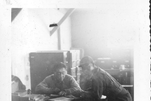 Two Nisei men in camp office (ddr-densho-157-50)