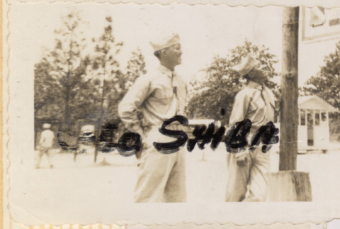 Two men looking up at sign (ddr-densho-466-226)