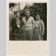 Three adults posing outside (ddr-densho-433-599)