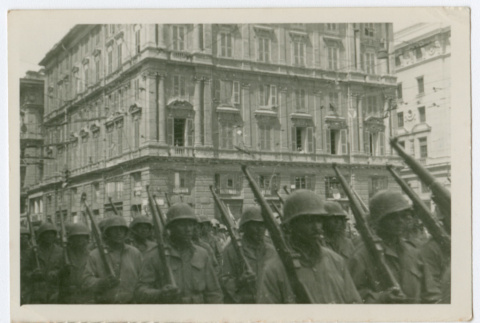 Soldiers marching in city street with rifles (ddr-densho-368-101)
