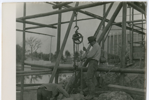 Laborers moving rock with pulley (ddr-densho-377-1636)