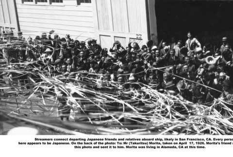 View of large crowd on dock by ship with streamers taken from ship (ddr-ajah-6-595)