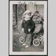 Photo of a child next to a pram (ddr-densho-483-715)