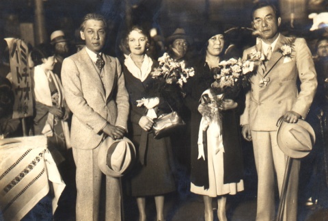 Two women holding bouquets, posing with husbands (ddr-njpa-4-137)