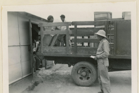 Unloading crates at a warehouse (ddr-densho-37-864)