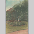 Woman watering flowers (ddr-densho-523-23)